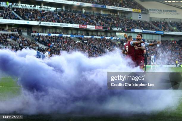Danny Ings of Aston Villa celebrates with teammates after scoring their side's second goal during the Premier League match between Brighton & Hove...
