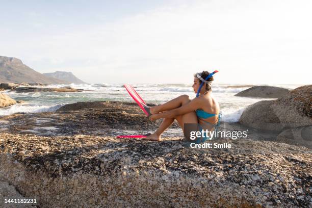 young woman putting on flippers - person putting a mask stock pictures, royalty-free photos & images