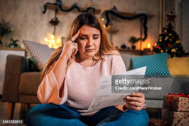 worried woman manage finances - christmas stress stock pictures, royalty-free photos & images