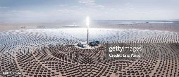 aerial panorama of molten salt solar power station - tower stock-fotos und bilder