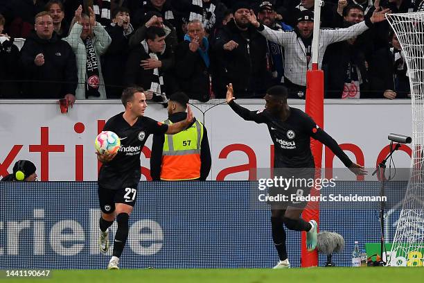 Randal Kolo Muani of Eintracht Frankfurt celebrates scoring their side's first goal with teammate Mario Gotze during the Bundesliga match between 1....