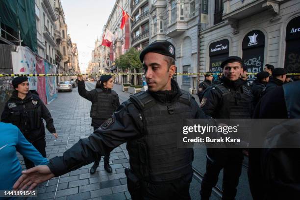 Police officers secure the area after an explosion on busy pedestrian Istiklal street on November 13, 2022 in Istanbul, Turkey. At least six people...