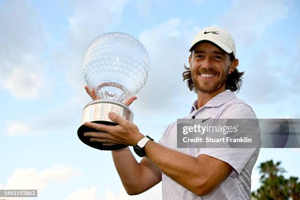 Tommy Fleetwood of England poses with the Nedbank Golf Challenge trophy after winning the Nedbank Golf Challenge on the 18th hole during Day Four of...