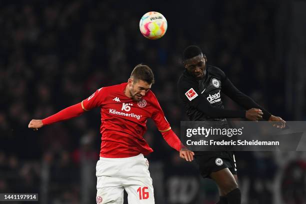 Stefan Bell of 1.FSV Mainz 05 contends for the aerial ball with Randal Kolo Muani of Eintracht Frankfurt during the Bundesliga match between 1. FSV...