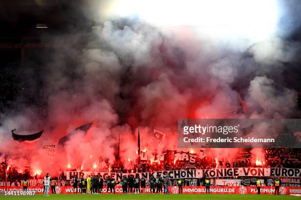 General view as players of Eintracht Frankfurt acknowledge their fans, who use smoke flares, after the final whistle of the Bundesliga match between...