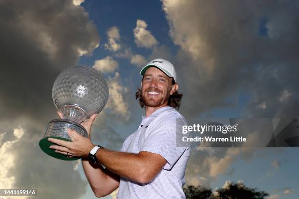 Tommy Fleetwood of England poses with the Nedbank Golf Challenge trophy after winning the Nedbank Golf Challenge on the 18th hole during Day Four of...