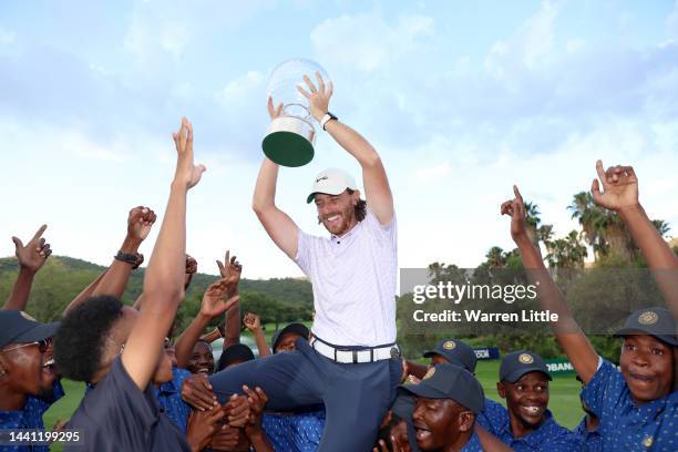 Tommy Fleetwood of England is thrown to the air by the green keepers with the Nedbank Golf Challenge trophy after winning the Nedbank Golf Challenge...