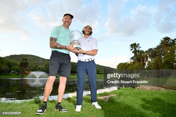 Tommy Fleetwood of England and his caddie Ian Finnis poses with the Nedbank Golf Challenge trophy after winning the Nedbank Golf Challenge on the...