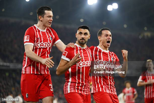 Vincenzo Grifo celebrates after scoring his team's first goal with Michael Gregoritsch Nicolas Hoefler of Freiburg during the Bundesliga match...