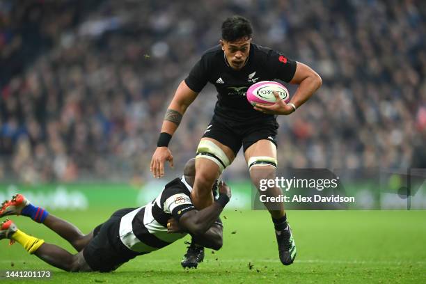 Bailyn Sullivan of New Zealand is tackled by Raymond Rhule of Barbarians during the Killik Cup match between Barbarians and New Zealand All Blacks XV...