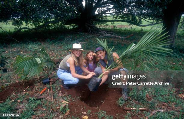 1990s: Australian actress and singer Olivia Newton-John with her husband Matt Lattanzi and their daughter Chloe in the garden of their home in the...