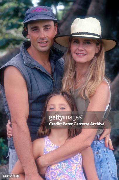 1990s: Australian actress and singer Olivia Newton-John with her husband Matt Lattanzi and their daughter Chloe in the garden of their home in the...