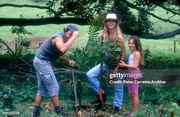 1990s: Australian actress and singer Olivia Newton-John with her husband Matt Lattanzi and their daughter Chloe in the garden of their home in the...