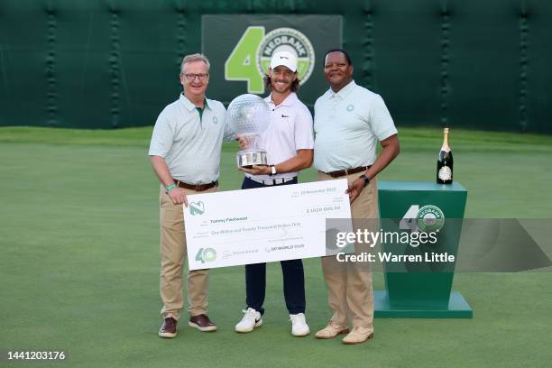 Tommy Fleetwood of England; Mike Brown CE of Ned Bank Group; Mpho Makwana, chairman of Nedbank Group poses with the trophy during the prize ceremony...