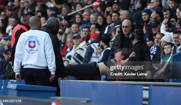 Femen activist is ejected by security during the Ligue 1 match between Paris Saint-Germain and AJ Auxerre at Parc des Princes on November 13, 2022 in...