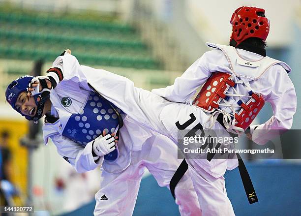 Mayu Hamada of Japan in action against Feng Xiao of Macao during day two of the 20th Asian Taekwondo Championships at Phu Tho Stadium on May 10, 2012...