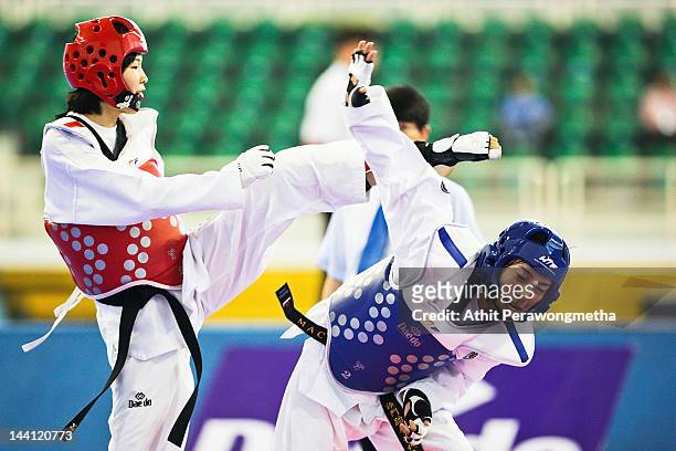 Mayu Hamada of Japan in action against Feng Xiao of Macao during day two of the 20th Asian Taekwondo Championships at Phu Tho Stadium on May 10, 2012...