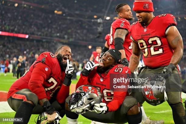 Donovan Smith, Rakeem Nunez-Roches and William Gholston of the Tampa Bay Buccaneers celebrate their side's win after the final play of the NFL match...