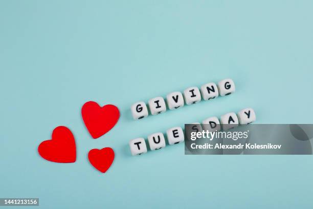 giving tuesday donate charity concept with text blue background - giving tuesday stock pictures, royalty-free photos & images