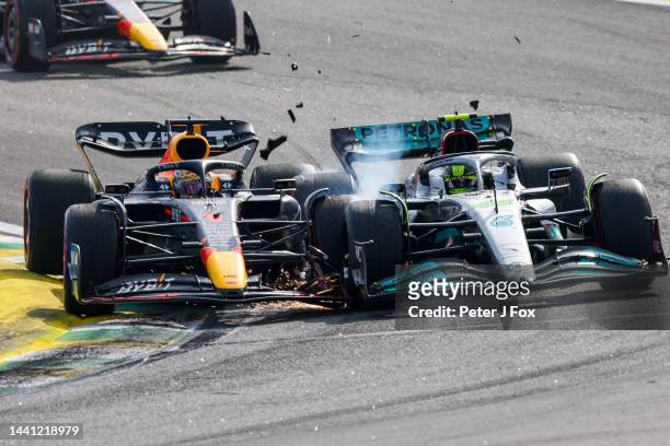 Max Verstappen of Red Bull Racing and The Netherlands and Lewis Hamilton of Mercedes and Great Britain clash at turn 2 during the F1 Grand Prix of...