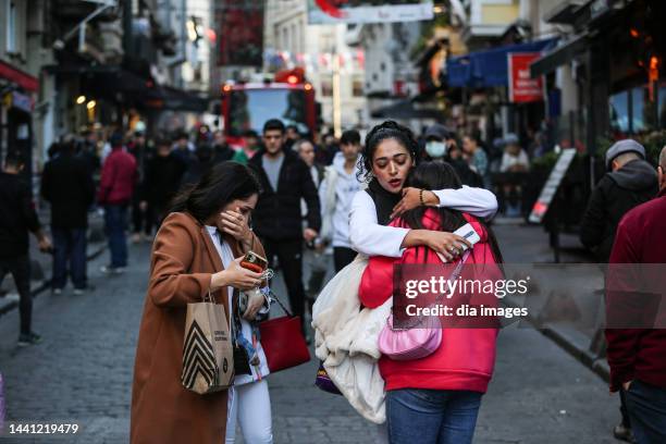 People react at the scene after an explosion occurred on Istiklal street, a busy pedestrian thoroughfare on November 13, 2022 in Istanbul, Turkey. It...