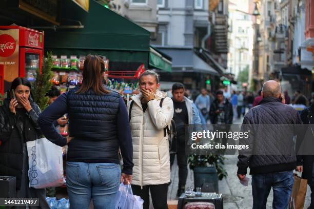 People react at the scene after an explosion occurred on Istiklal street, a busy pedestrian thoroughfare on November 13, 2022 in Istanbul, Turkey. It...