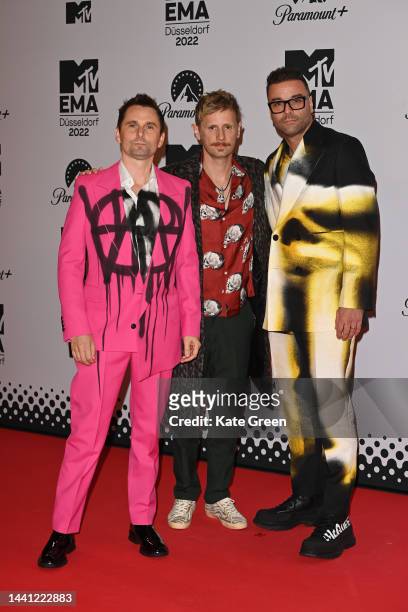 Matthew Bellamy, Dominic Howard and Chris Wolstenholme of Muse attend the red carpet during the MTV Europe Music Awards 2022 held at PSD Bank Dome on...