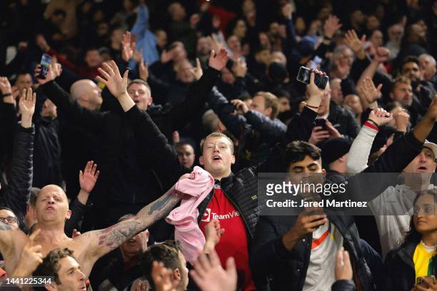 Manchester United fans celebrate after the Premier League match between Fulham FC and Manchester United at Craven Cottage on November 13, 2022 in...