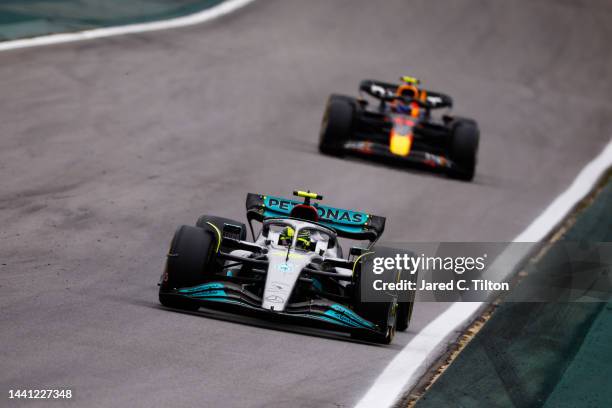 Lewis Hamilton of Great Britain driving the Mercedes AMG Petronas F1 Team W13 leads Sergio Perez of Mexico driving the Oracle Red Bull Racing RB18...