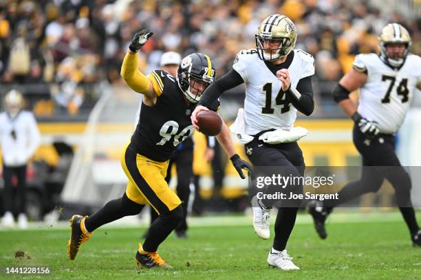 Andy Dalton of the New Orleans Saints is chased by T.J. Watt of the Pittsburgh Steelers during the second quarter at Acrisure Stadium on November 13,...