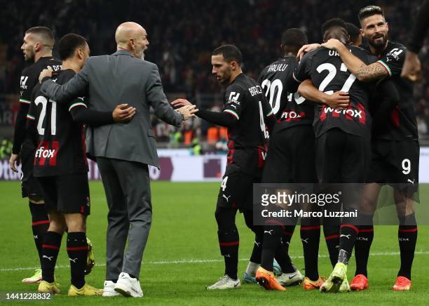 Milan players celebrate a team-mates goal during the Serie A match between AC Milan and ACF Fiorentina at Stadio Giuseppe Meazza on November 13, 2022...