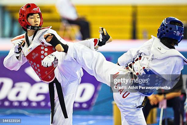 Mayu Hamada of Japan in action against Feng Xiao of Macao during day two of the 20th Asian Taekwondo Championships at Phu Tho Stadium on May 10, 2012...