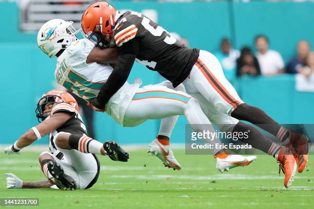 Deion Jones of the Cleveland Browns tackles Raheem Mostert of the Miami Dolphins in the first quarter of the game at Hard Rock Stadium on November...