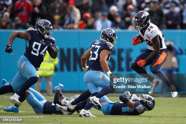 Latavius Murray of the Denver Broncos jumps over a defender during the second quarter against the Tennessee Titans at Nissan Stadium on November 13,...