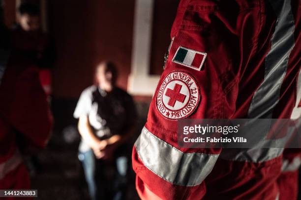 The Red Cross emblem of a Red Cross volunteer's uniform during a night service to assist the homeless. They bring hot food and blankets to the poor...
