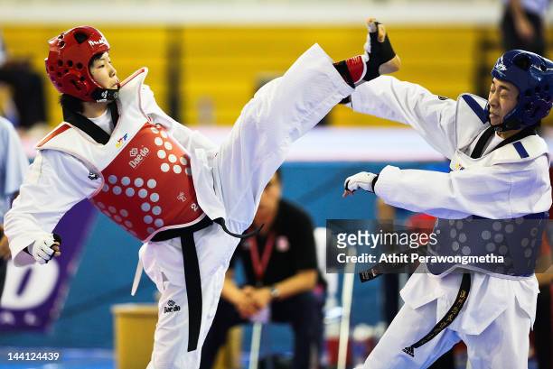 Mayu Hamada of Japan in action against Feng Xiao of Macao during day two of the 20th Asian Taekwondo Championships at Phu Tho Stadium on May 10, 2012...