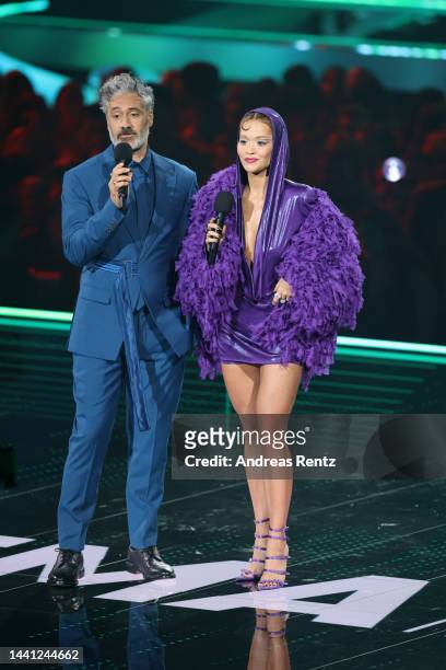 Hosts Taika Waititi and Rita Ora speak on stage during the MTV Europe Music Awards 2022 held at PSD Bank Dome on November 13, 2022 in Duesseldorf,...