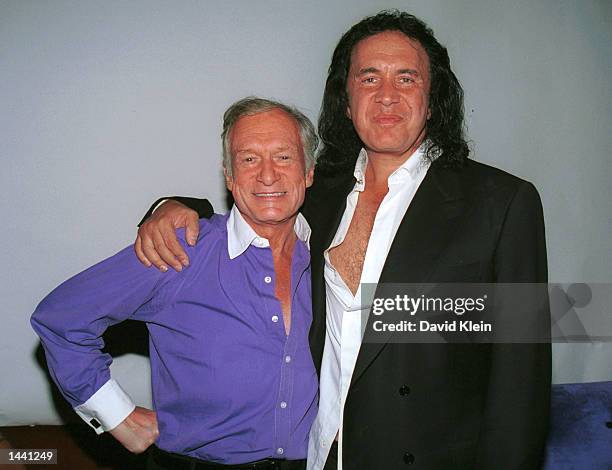Kiss bassist Gene Simmons poses with Playboy founder, Hugh Hefner, during the Tongue Magazine Fall 2002 Issue release party featuring covergirl,...