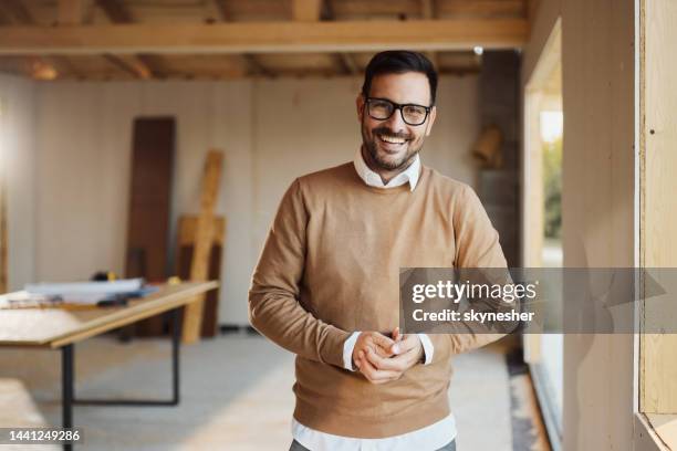 young happy man inside of a built structure. - real estate developer stock pictures, royalty-free photos & images