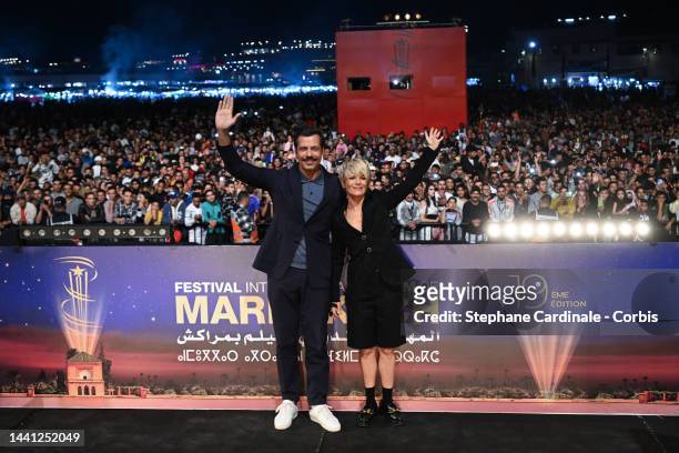 Laurent Lafitte and Marina Fois attend the "Papa ou Maman" screening at Jemaa El Fna Place during the 19th Marrakech International Film Festival -...