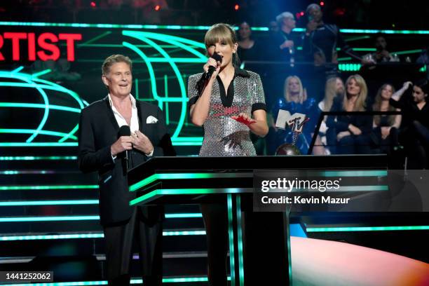 Taylor Swift accepts an award onstage from David Hasselhoff during the MTV Europe Music Awards 2022 held at PSD Bank Dome on November 13, 2022 in...