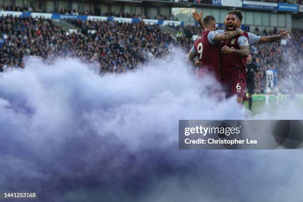 Douglas Luiz of Aston Villa celebrates their second goal with goalscorer Danny Ings during the Premier League match between Brighton & Hove Albion...