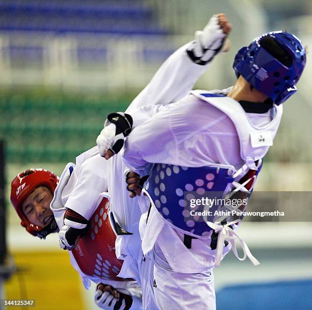 Lee Dong-Eon of Korea in action against Dela Cruz Al Christian of Philippines during day two of the 20th Asian Taekwondo Championships at Phu Tho...