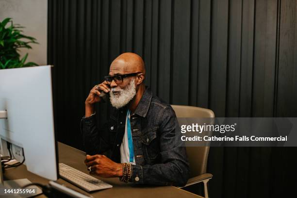 a male receptionist answers a phone - bell telephone company stock pictures, royalty-free photos & images