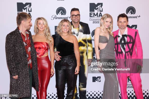 Dominic Howard, a guest, Caris Ball, Chris Wolstenholme, Elle Evans and Matthew Bellamy of Muse attend the red carpet during the MTV Europe Music...