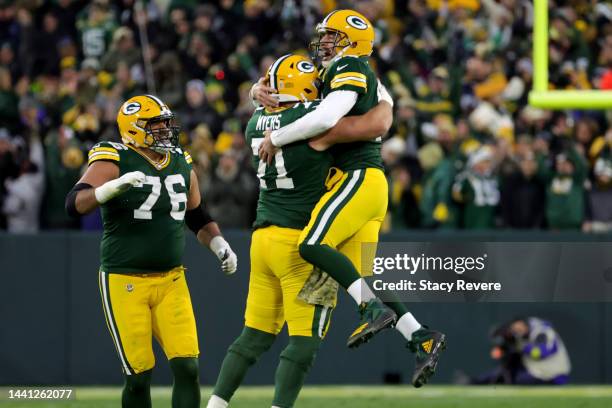 Jon Runyan of the Green Bay Packers celebrates as Josh Myers of the Green Bay Packers hugs Aaron Rodgers of the Green Bay Packers after a touchdown...