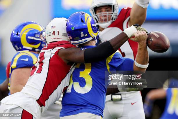 John Wolford of the Los Angeles Rams fumbles the ball after being hit by Myjai Sanders of the Arizona Cardinals in the second quarter of the game at...