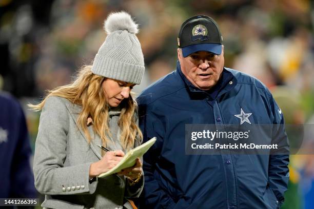 Erin Andrews interviews head coach Mike McCarthy of the Dallas Cowboys as he walks off the field at halftime against the Green Bay Packers at Lambeau...