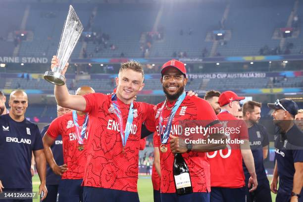 Sam Curran and Chris Jordan of England pose with the trophy as they celebrate victory in the ICC Men's T20 World Cup Final match between Pakistan and...