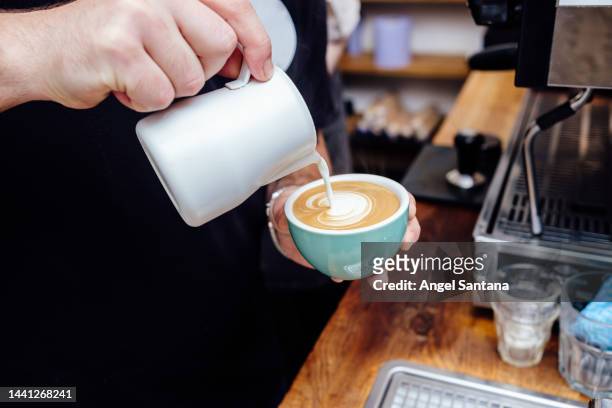 barista making cappuccino, bartender preparing coffee drink - milchschaum stock-fotos und bilder
